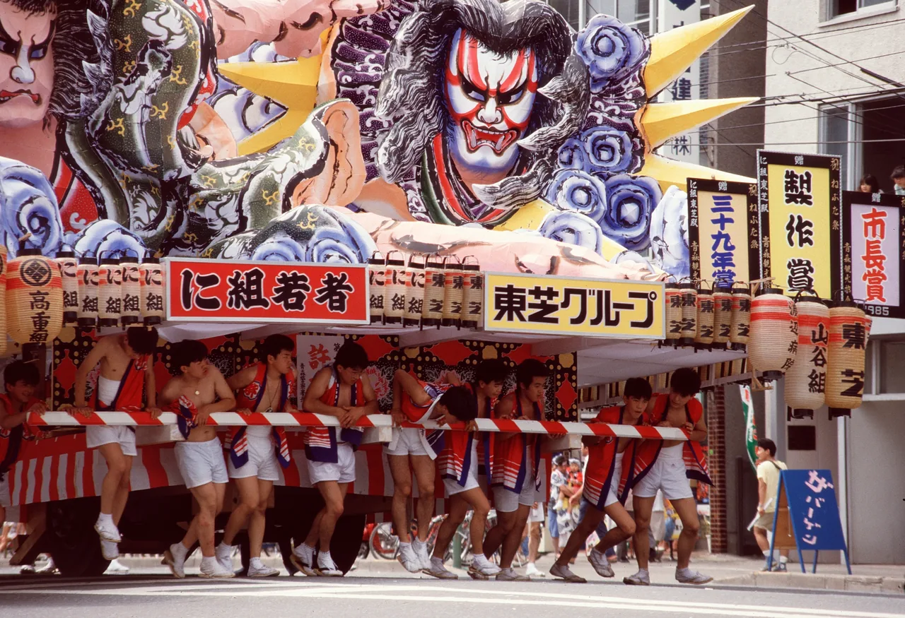 Giant illuminated Nebuta float parading at night during Aomori's August festival