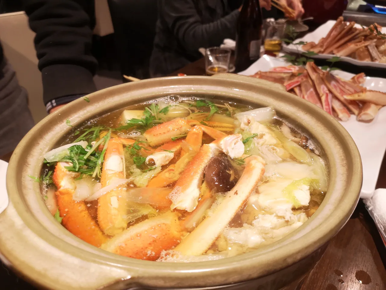 A Japanese snow crab hot pot simmering with crab legs and vegetables