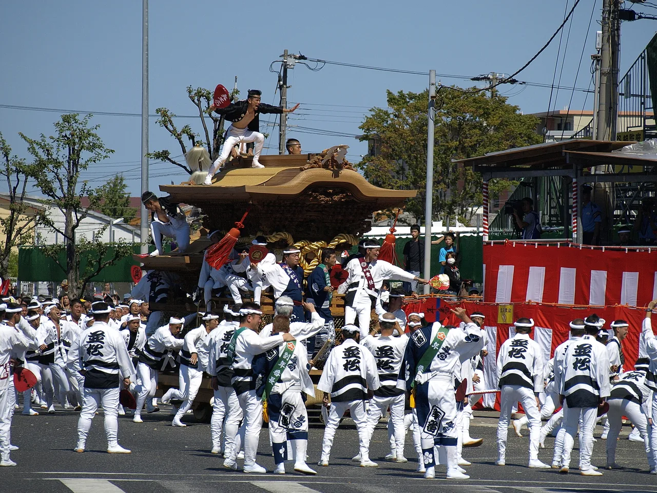 Teams hauling a heavy wooden danjiri float at speed through the streets of Kishiwada in September