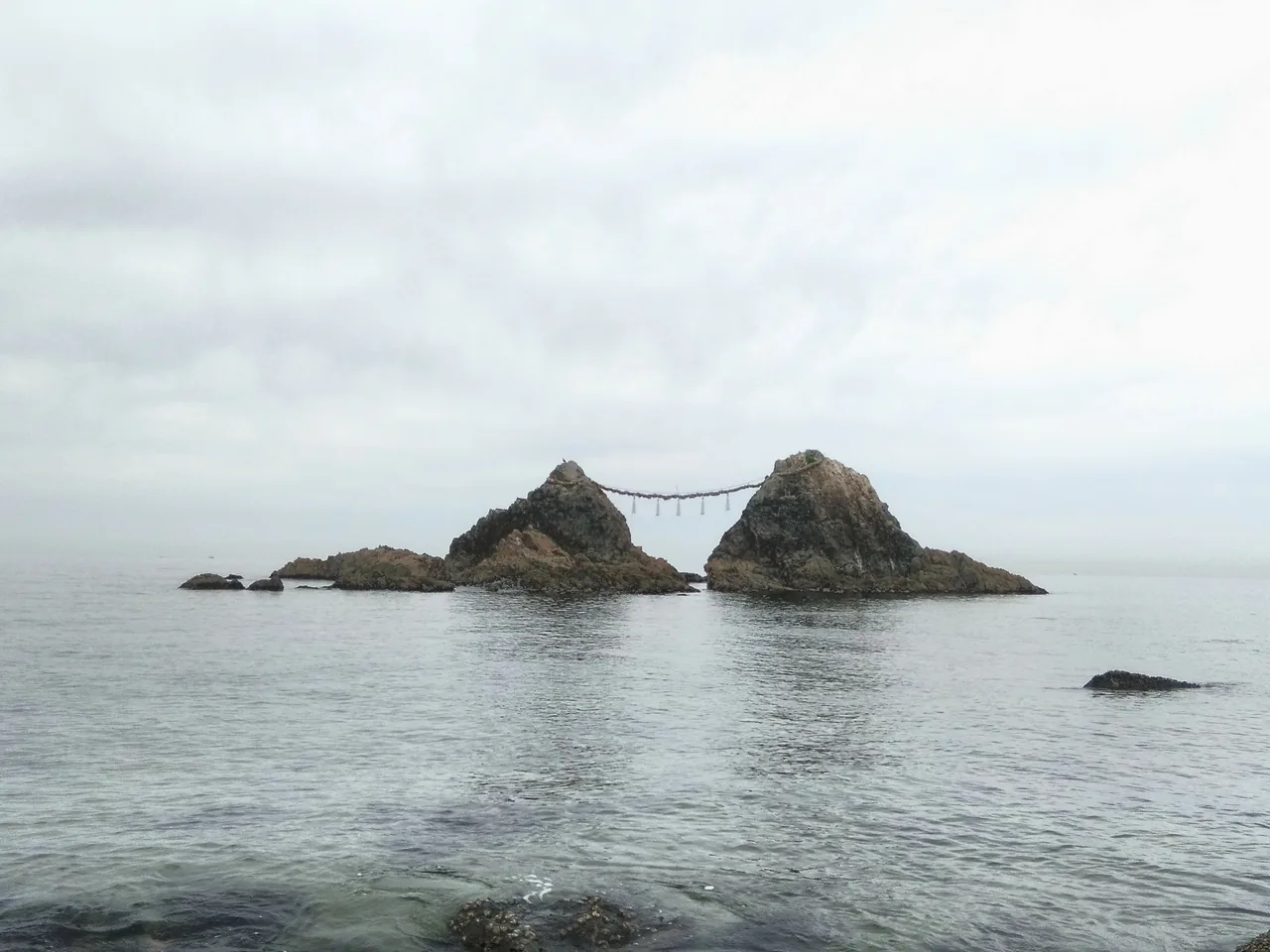 The Meoto Iwa married rocks joined by a sacred rope off the coast at Itoshima The Meoto Iwa married rocks joined by a sacred rope off the coast at Itoshima
