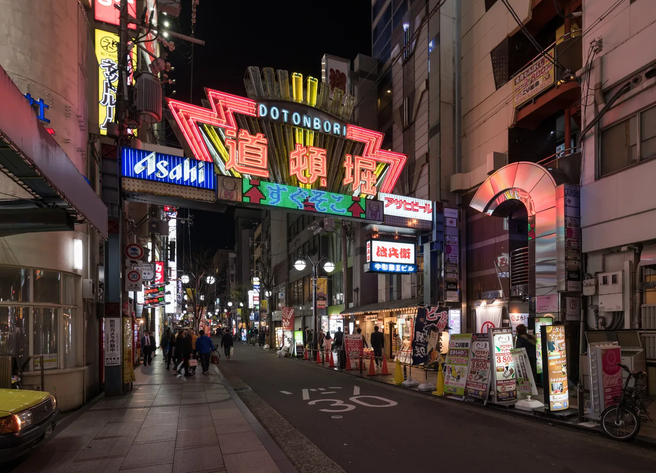 Neon signs reflected in the canal at Dotonbori in Osaka after dark Neon signs reflected in the canal at Dotonbori in Osaka after dark
