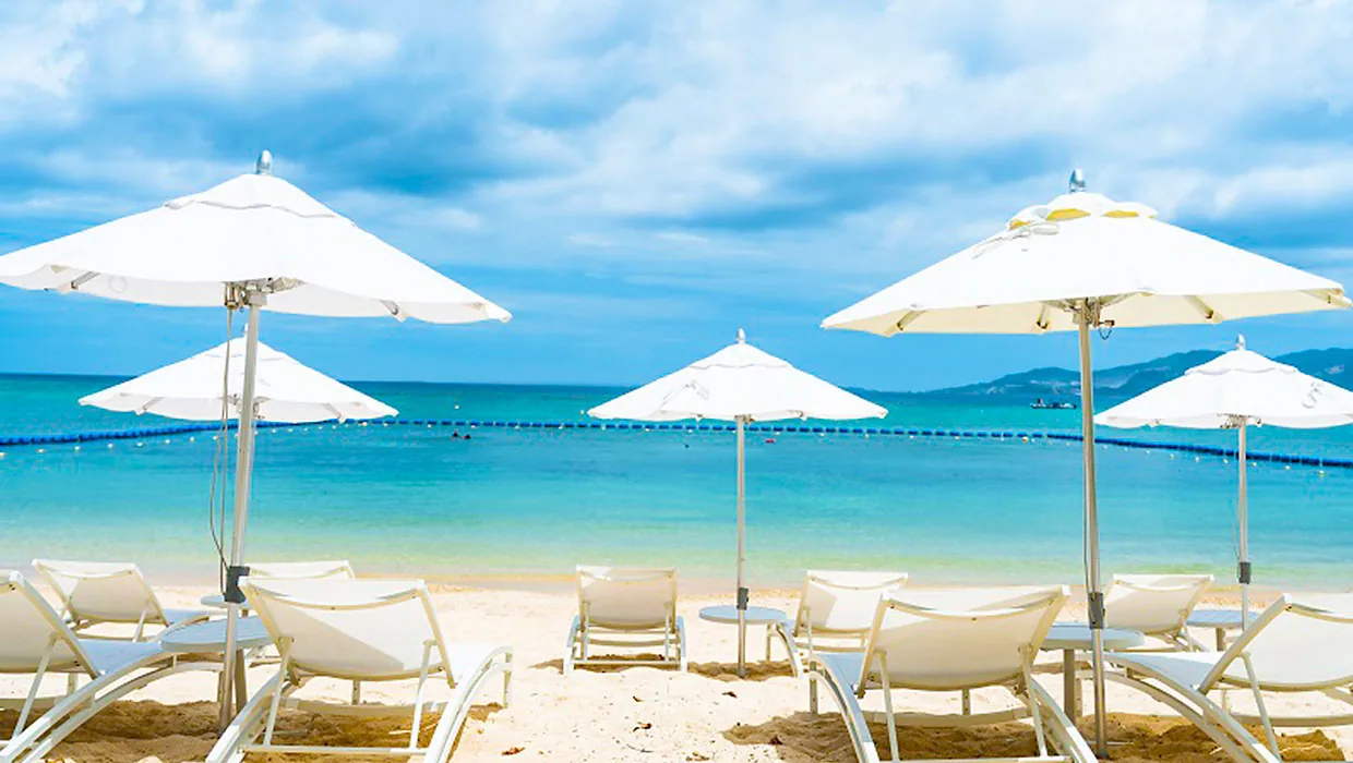 The resort beach and turquoise water in front of Halekulani Okinawa in Onna