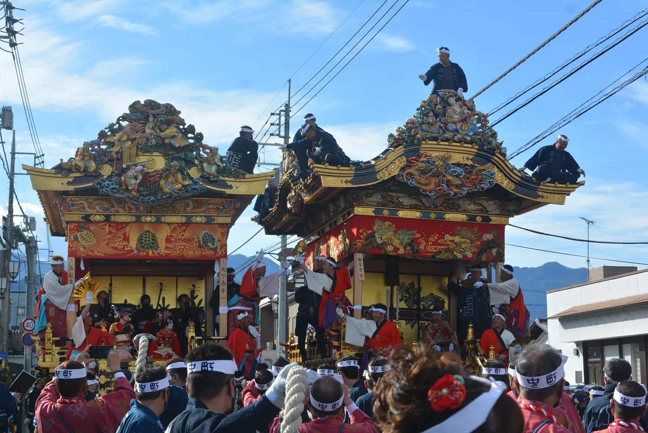 Two ornate wooden festival floats being pulled through the streets at the Chichibu Night Festival