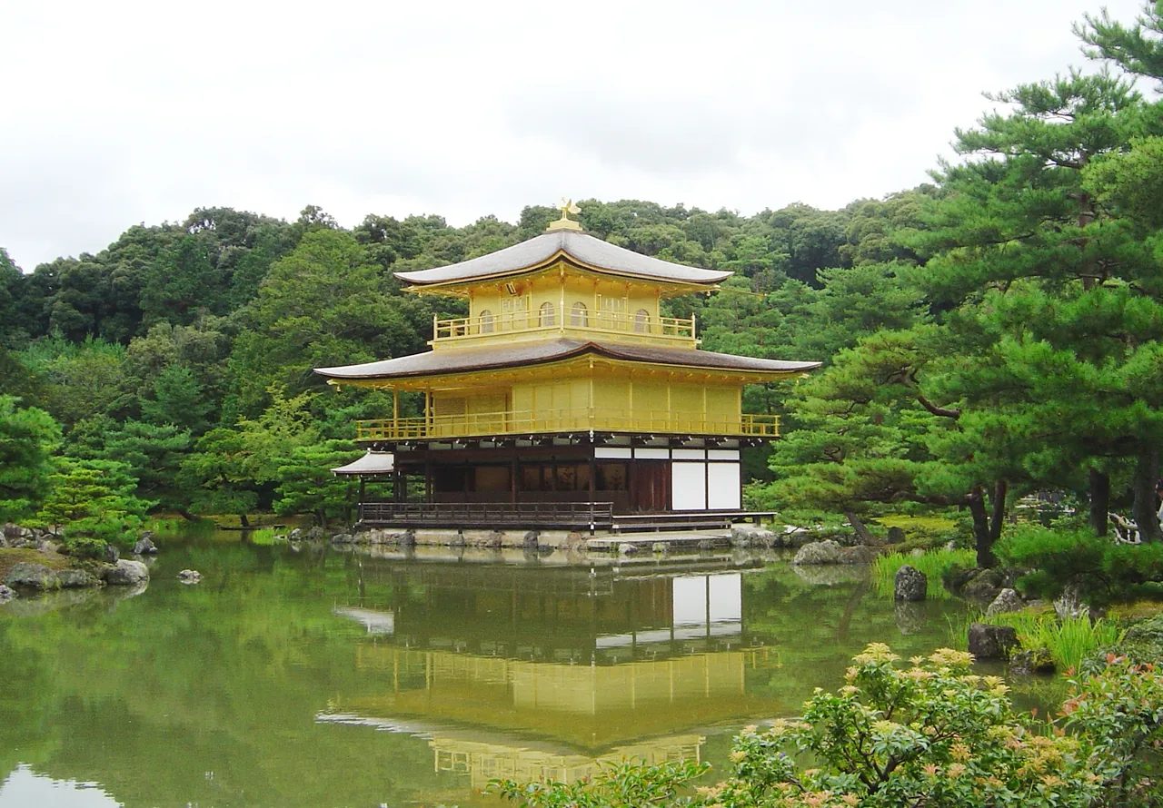Kinkaku-ji, the Golden Pavilion, reflected in its pond in Kyoto Kinkaku-ji, the Golden Pavilion, reflected in its pond in Kyoto