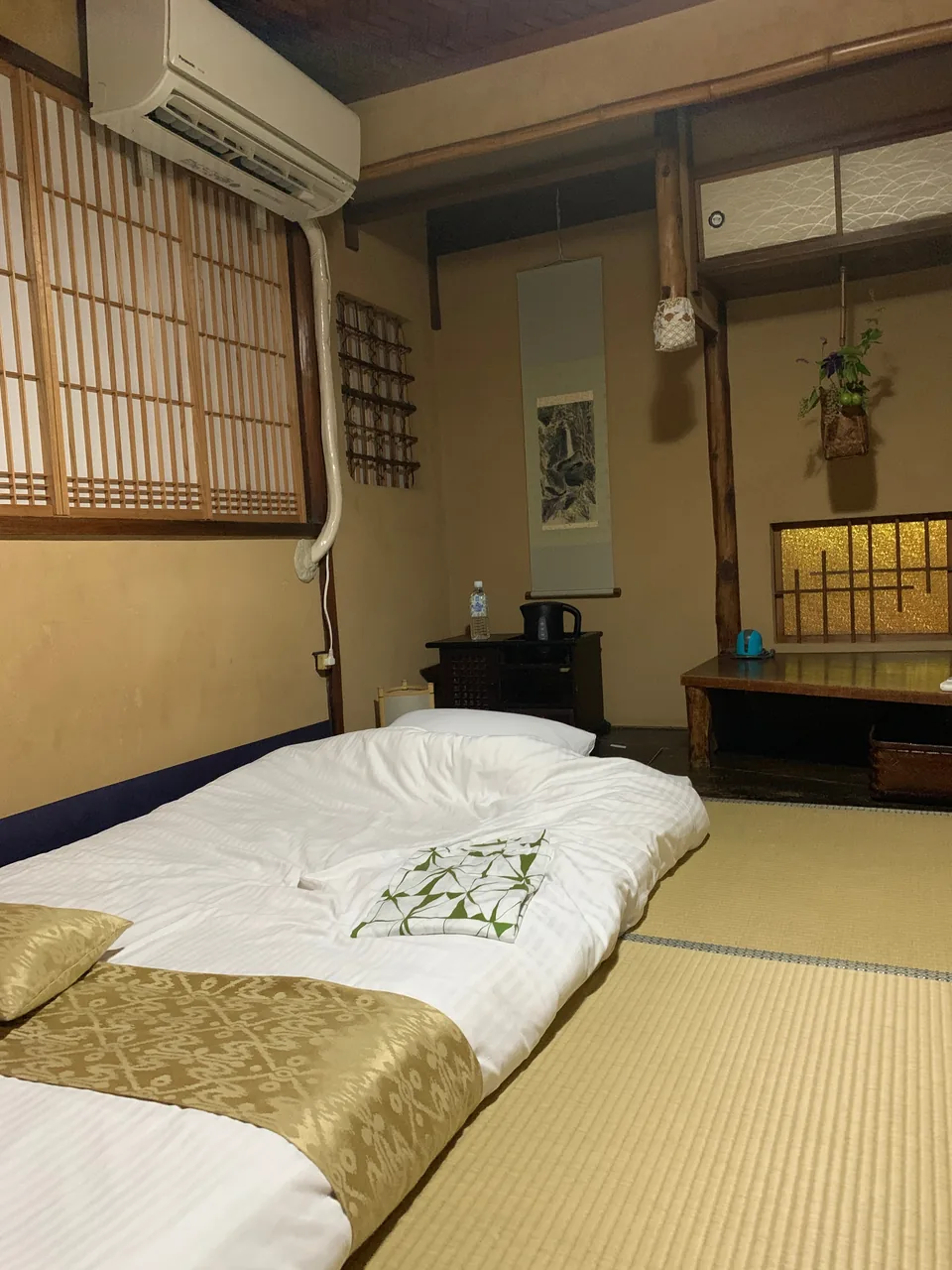 A traditional Kyoto ryokan room with tatami and futon bedding A traditional Kyoto ryokan room with tatami and futon bedding