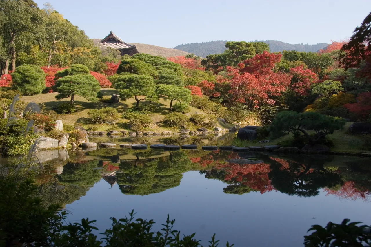 Isuien Garden in Nara with its pond and borrowed-scenery view in autumn Isuien Garden in Nara with its pond and borrowed-scenery view in autumn