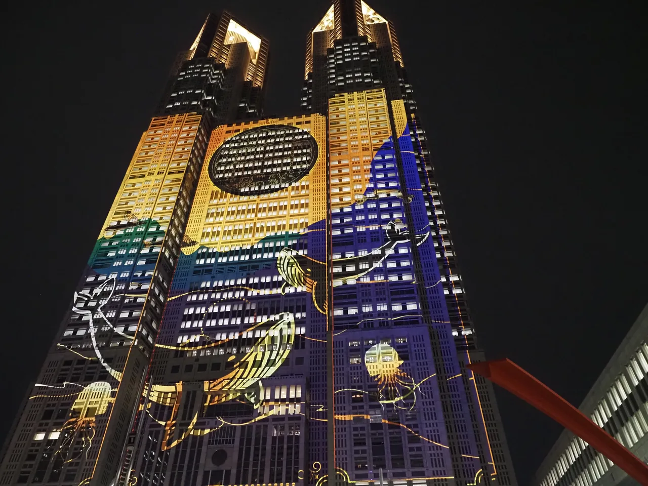 A projected image covering the east wall of Tokyo Metropolitan Government Building No. 1 at night