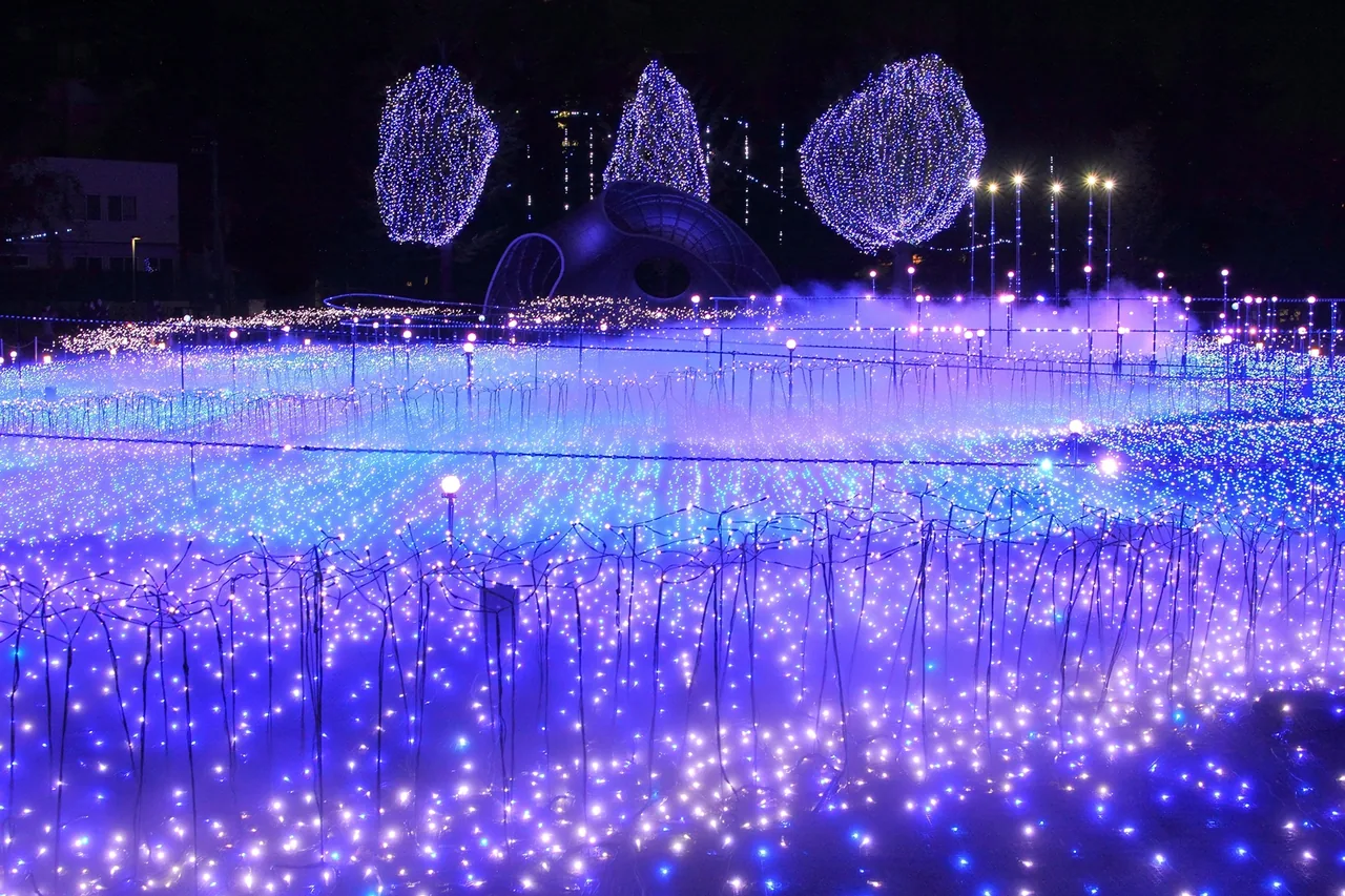 Winter lighting spread across the lawn of the Tokyo Midtown garden after dark