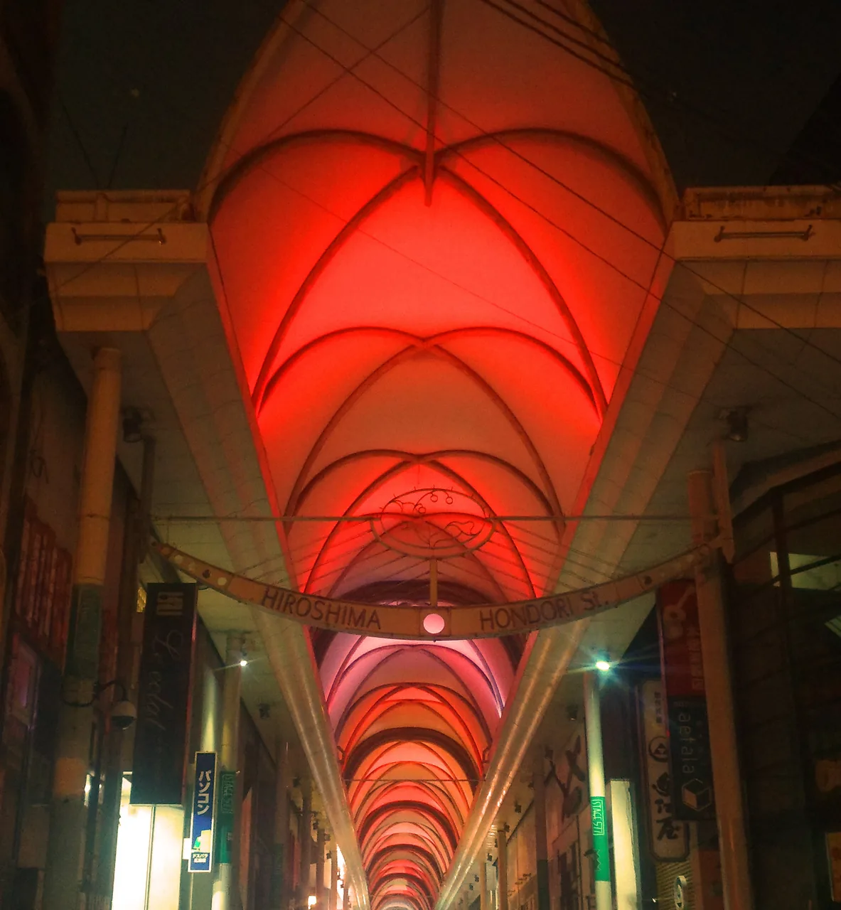 The vaulted ceiling of the Hondori shopping arcade in Hiroshima lit in red