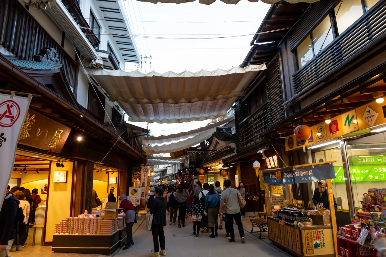 The roofed Omotesando shopping street on Miyajima lined with shops on both sides