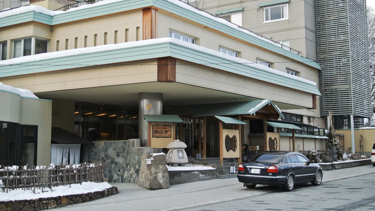 A hot spring ryokan in Jozankei outside Sapporo with snow banked along the entrance A hot spring ryokan in Jozankei outside Sapporo with snow banked along the entrance