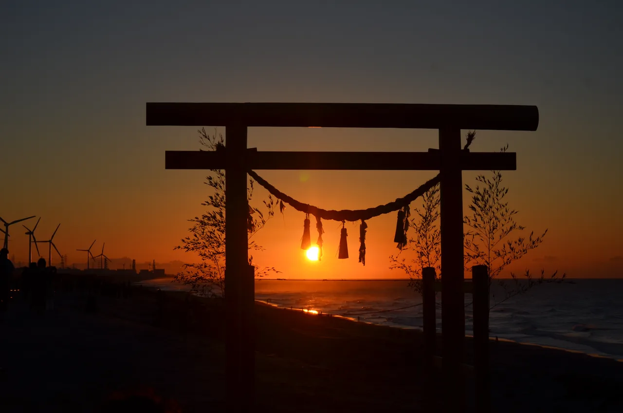 The first sunrise of the year seen through a shrine torii standing on the coast