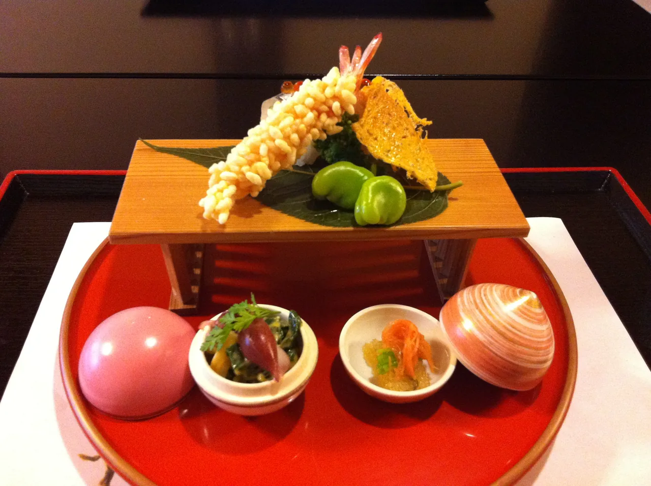 A kaiseki meal laid out as many small dishes, each one plated separately