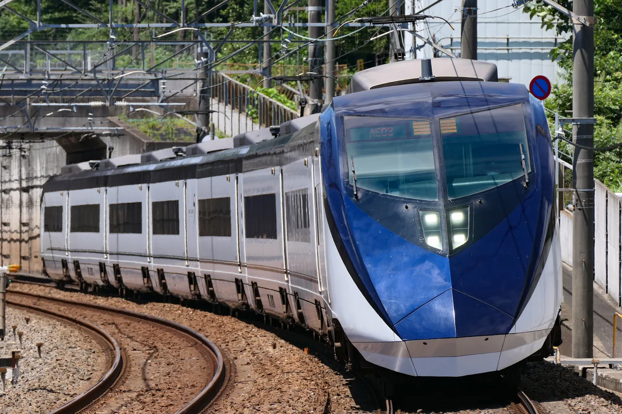 A dark blue Keisei Skyliner train on the track