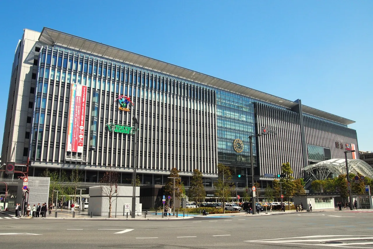 The long facade of the Hakata Station building seen from the street