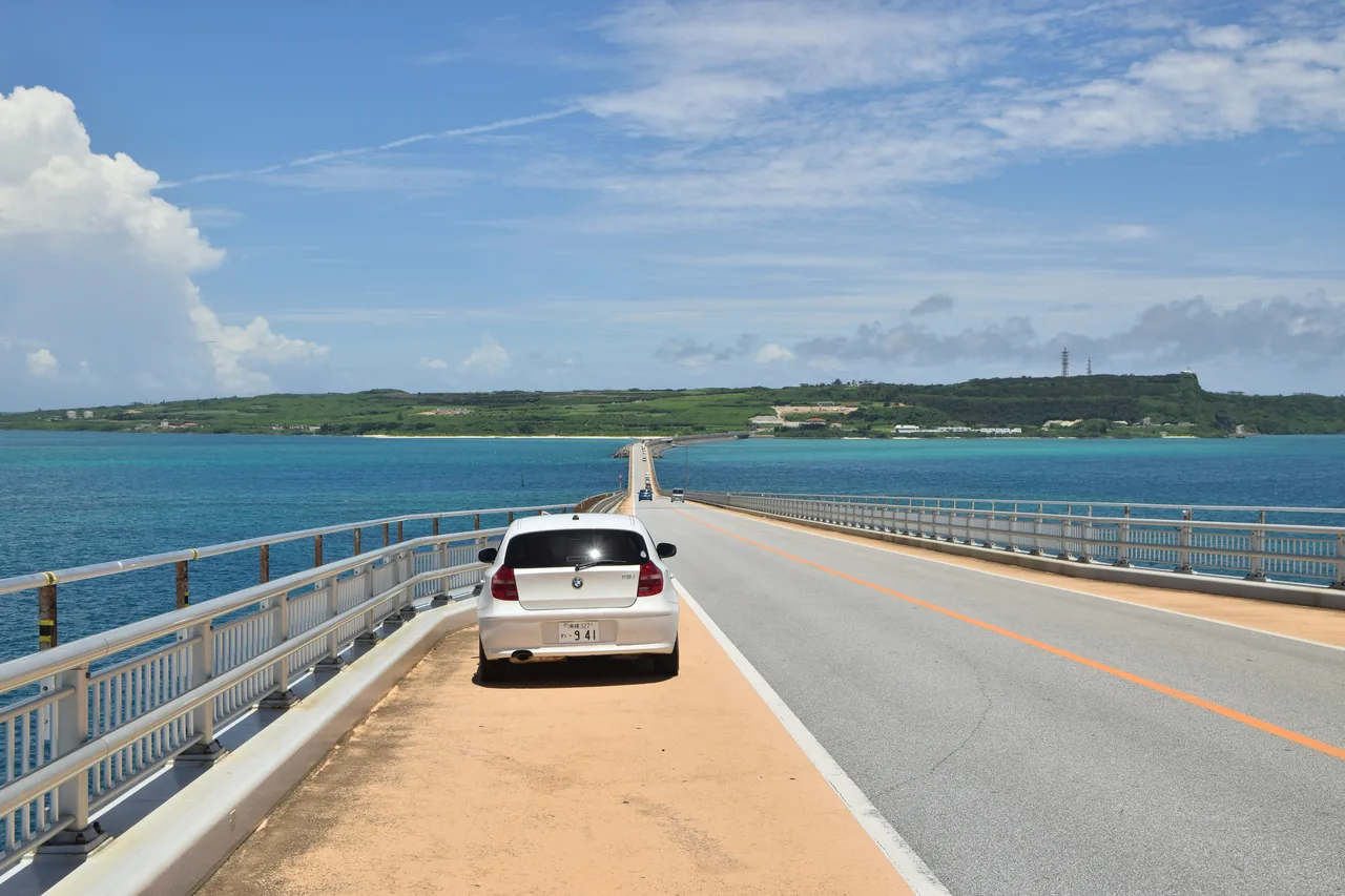 A bridge across the sea on Miyako Island with a car crossing it