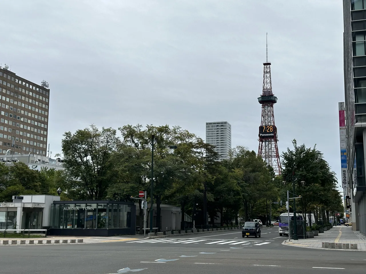 Odori Park in central Sapporo, a landscaped strip of lawn and trees between city blocks, with the Sapporo TV Tower at its east end.