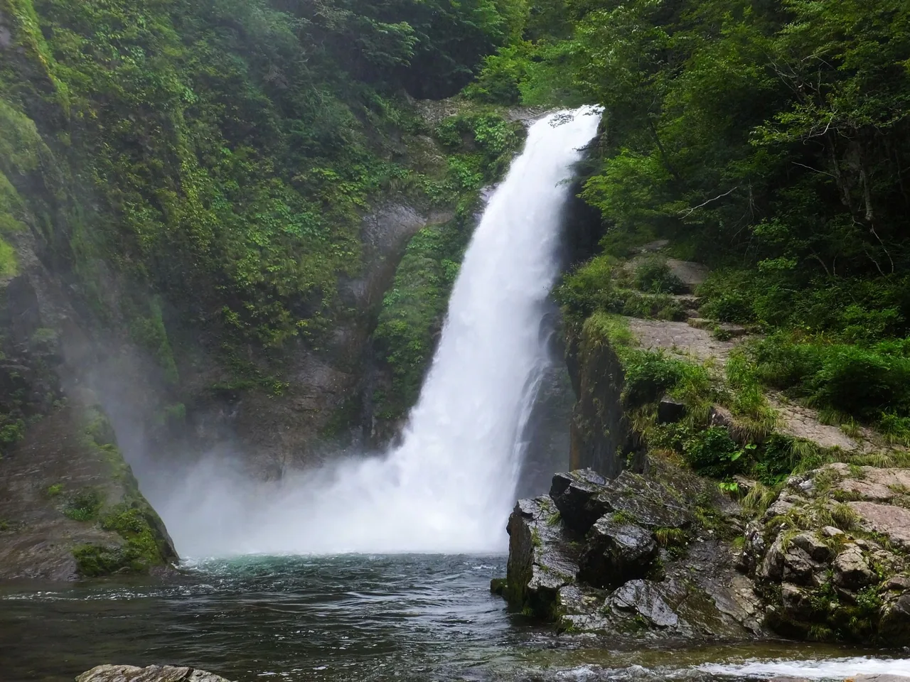 Akiu Otaki waterfall dropping in a single fall into a pool, surrounded by forest