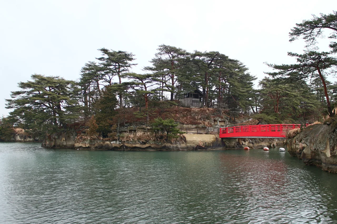 Pine covered islets in Matsushima Bay with a red bridge running out to one of them