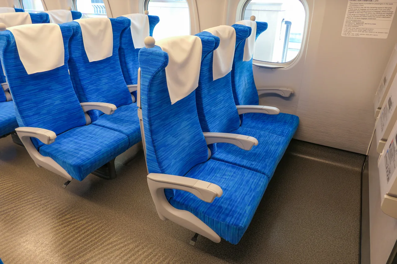 Three-abreast blue seats in an ordinary car of an N700S shinkansen Three-abreast blue seats in an ordinary car of an N700S shinkansen
