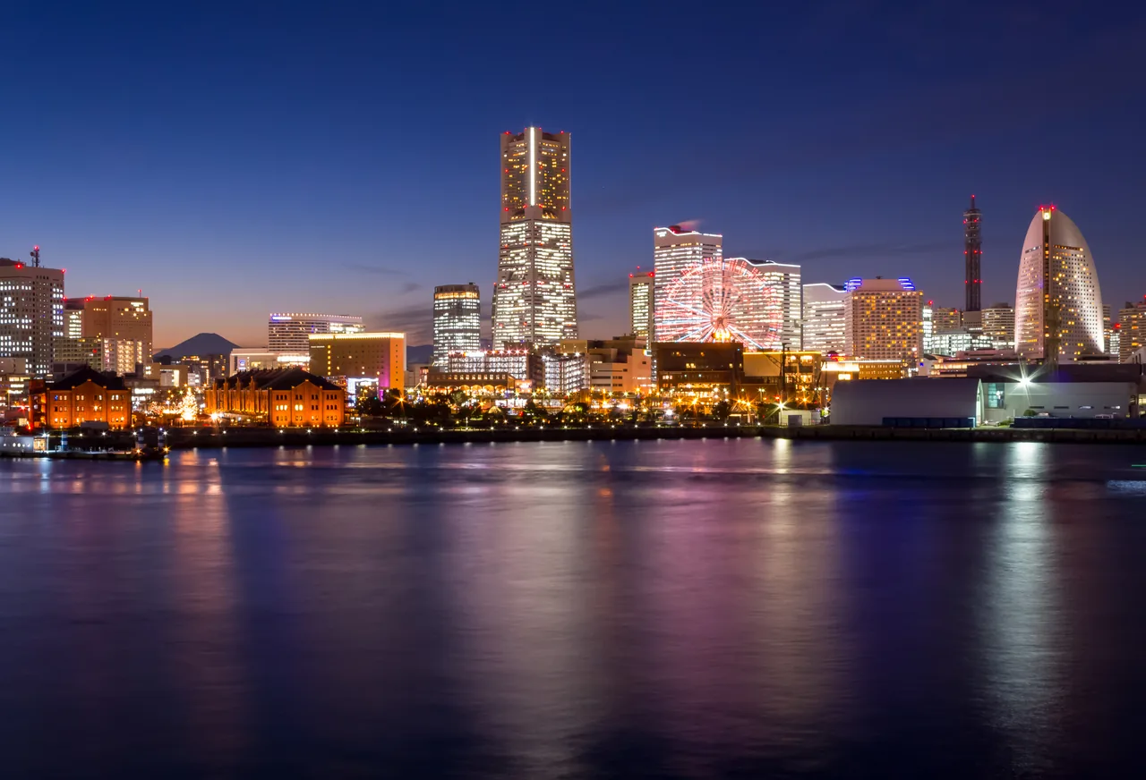 Minato Mirai in Yokohama at night, with Landmark Tower and the Cosmo Clock 21 ferris wheel reflected in the harbour water