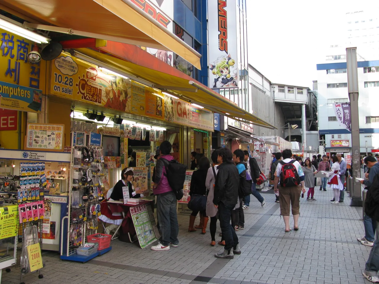 A busy Akihabara shopping street lined with shopfronts and signboards A busy Akihabara shopping street lined with shopfronts and signboards