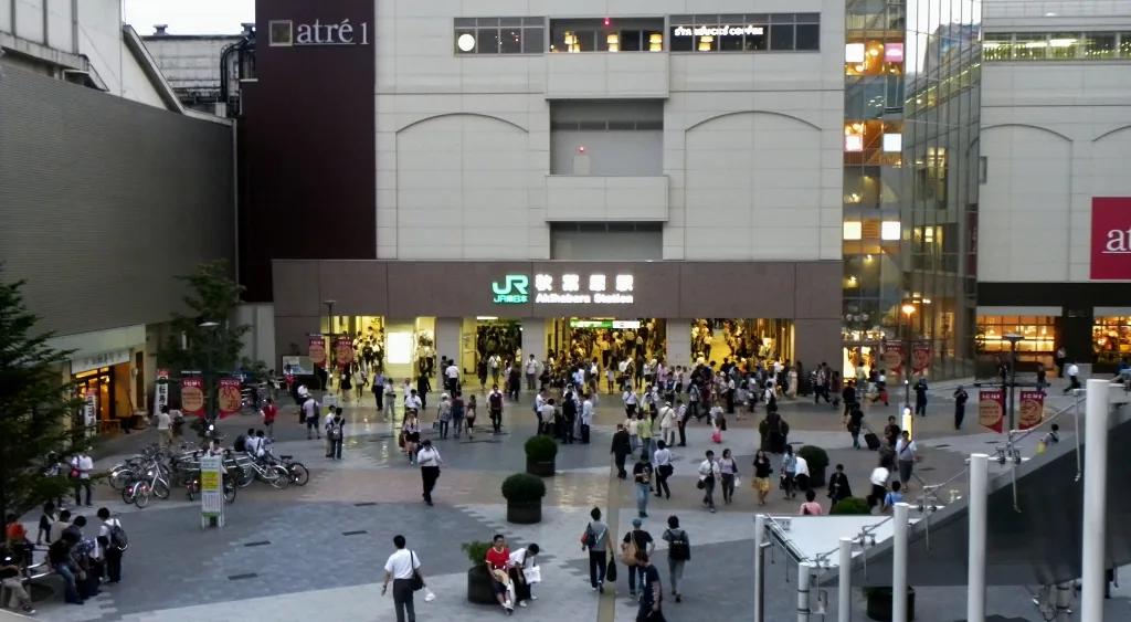 The plaza outside the Electric Town exit of Akihabara station with people crossing The plaza outside the Electric Town exit of Akihabara station with people crossing