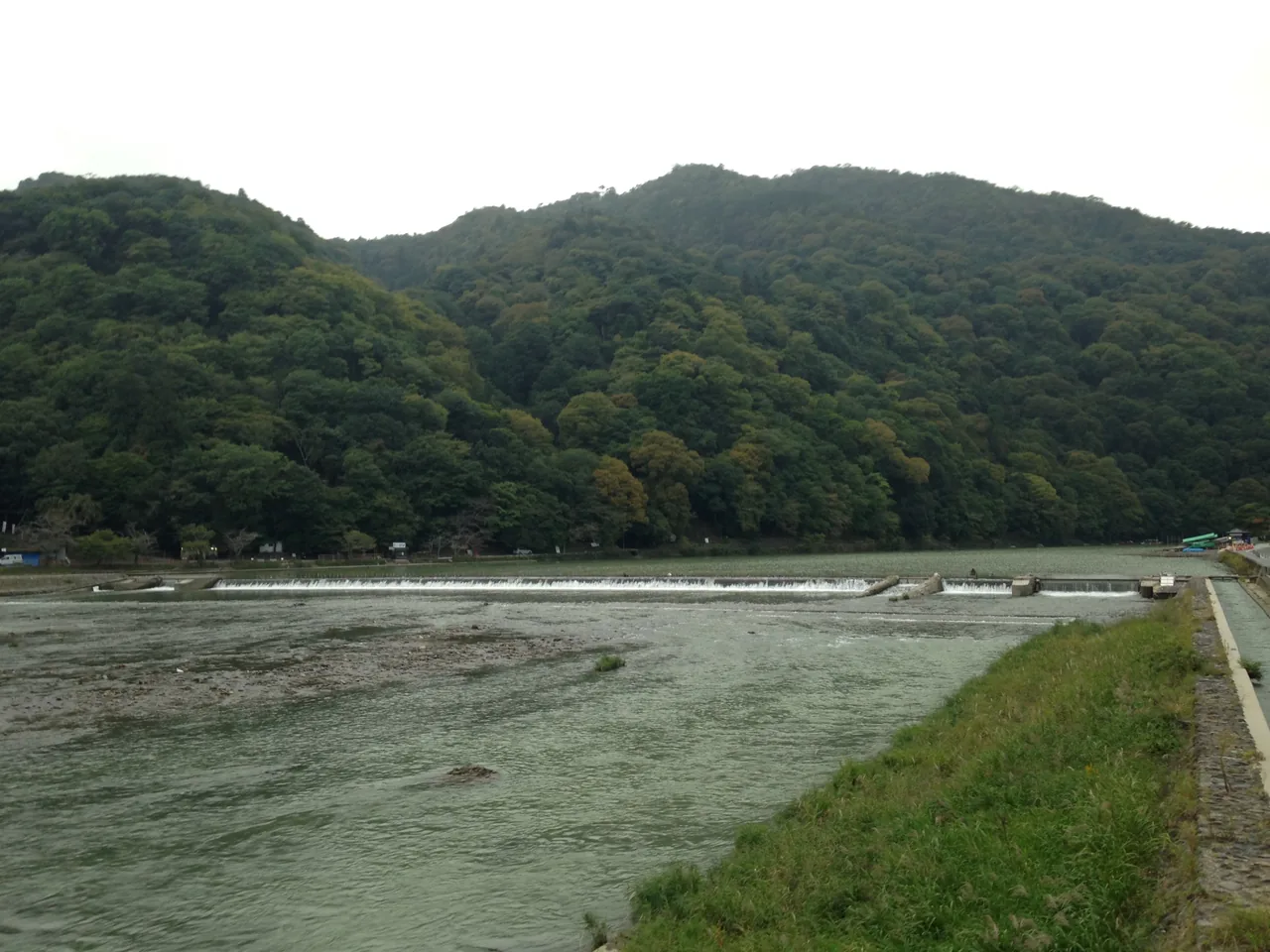 The weir on the Oi river seen from Togetsukyo Bridge with the mountain beyond