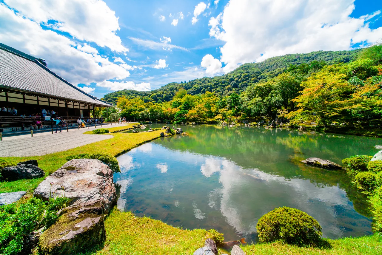 A pond and clipped planting in the hillside garden of Okochi Sanso