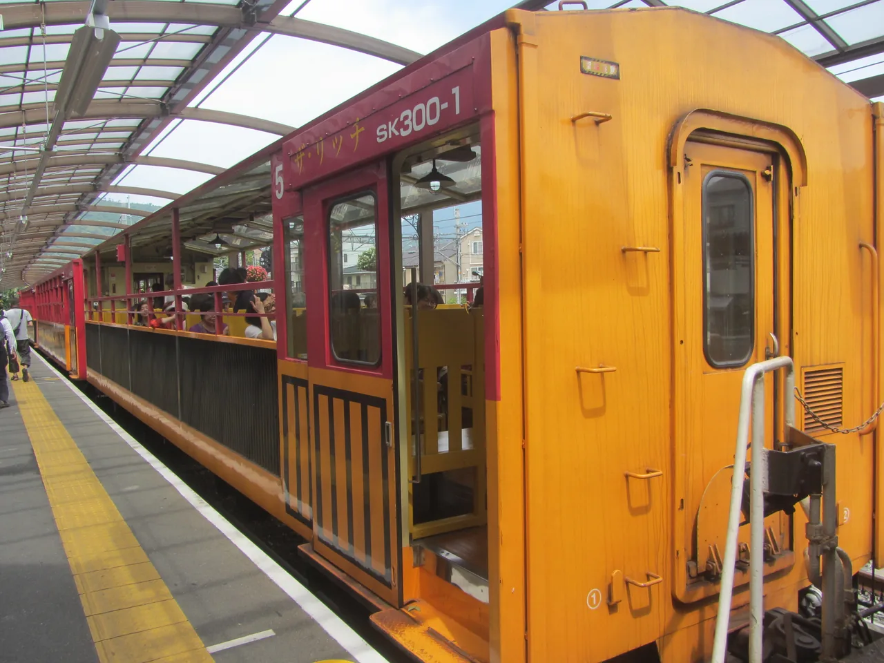 A passenger car of the Sagano Scenic Railway seen from the platform