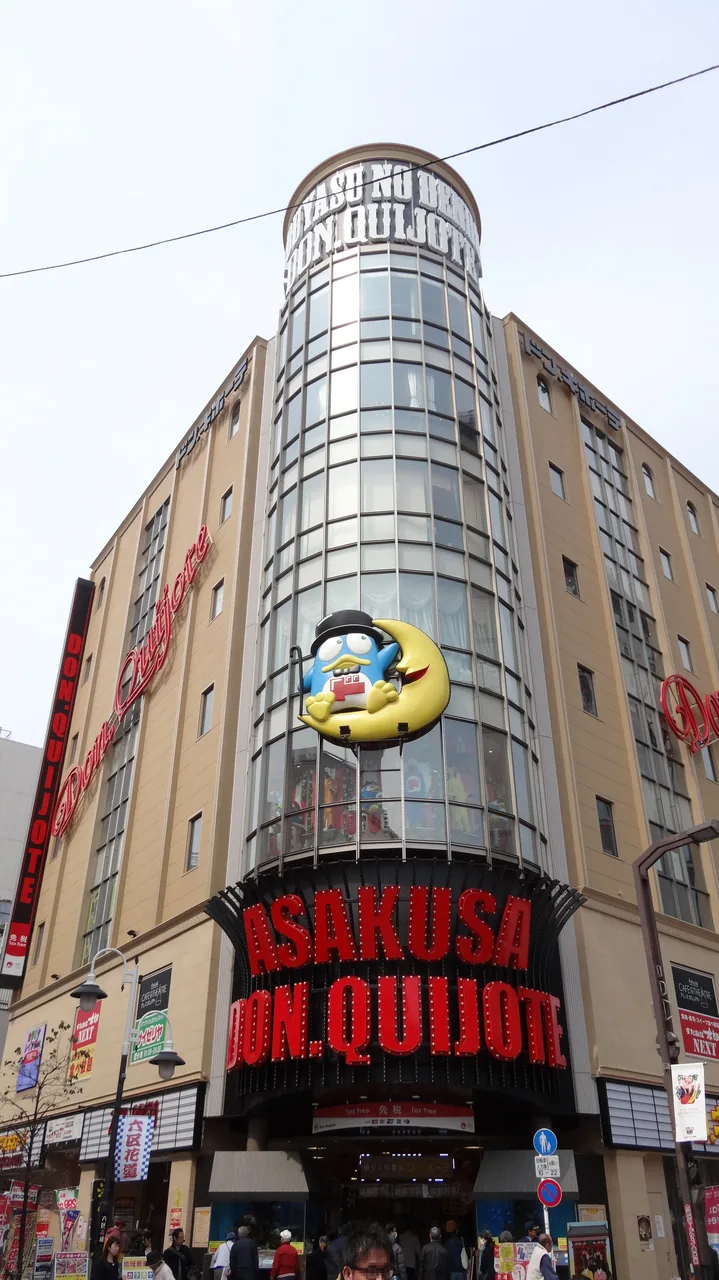 The Don Quijote store building in Asakusa with the penguin mascot on the wall