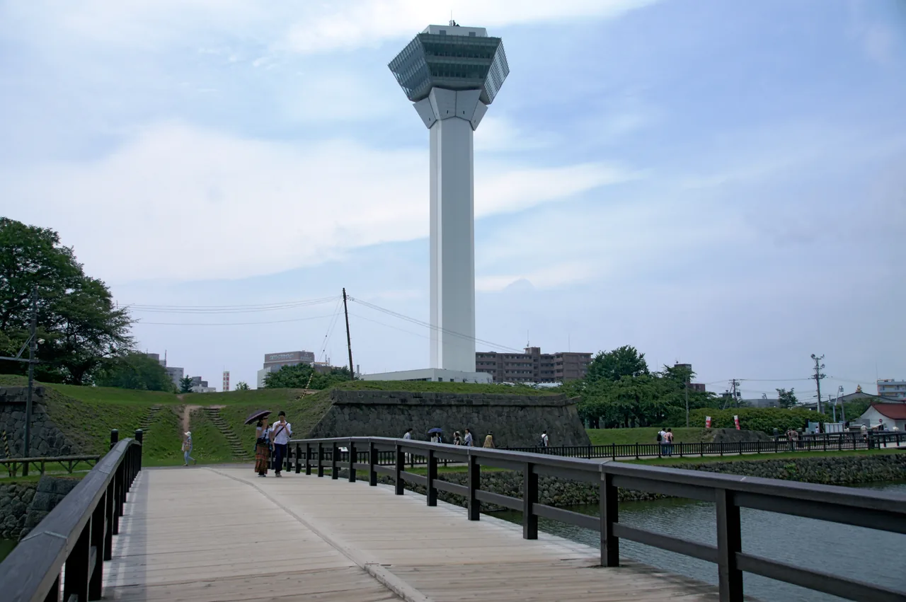 A concrete observation tower standing above the trees of the park