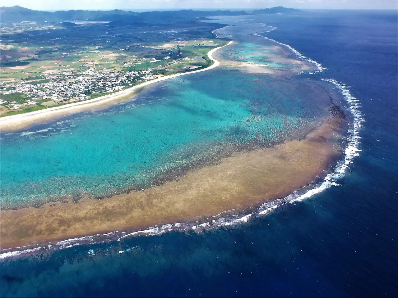 An aerial view of the Shiraho reef and the coastline beside the airport