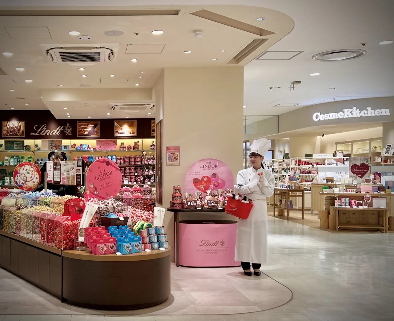 A chocolate shop in a shopping mall decorated with pink hearts