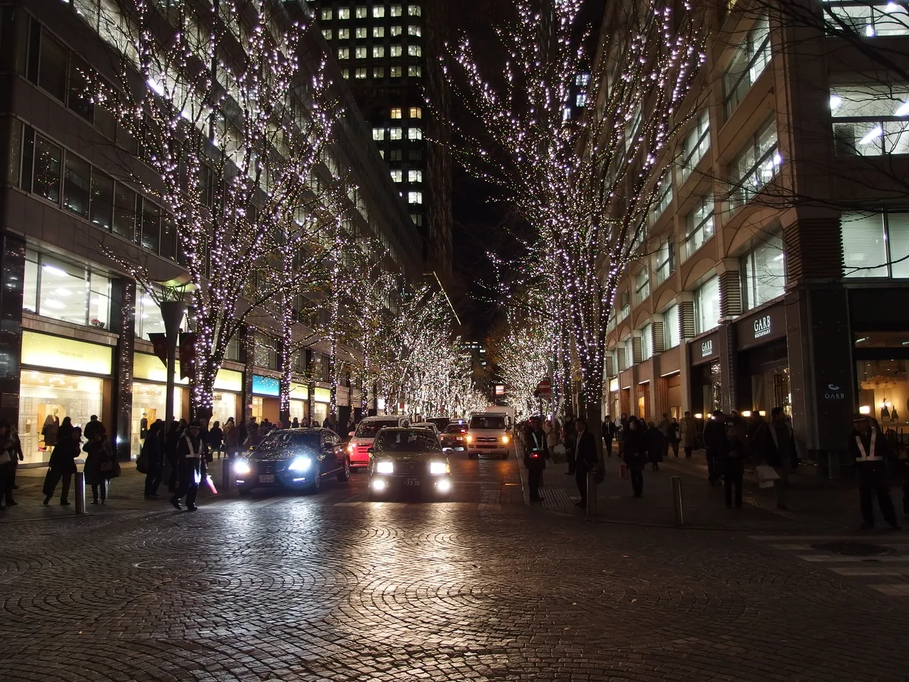 Marunouchi Naka-dori at night, bare street trees wrapped in white LEDs