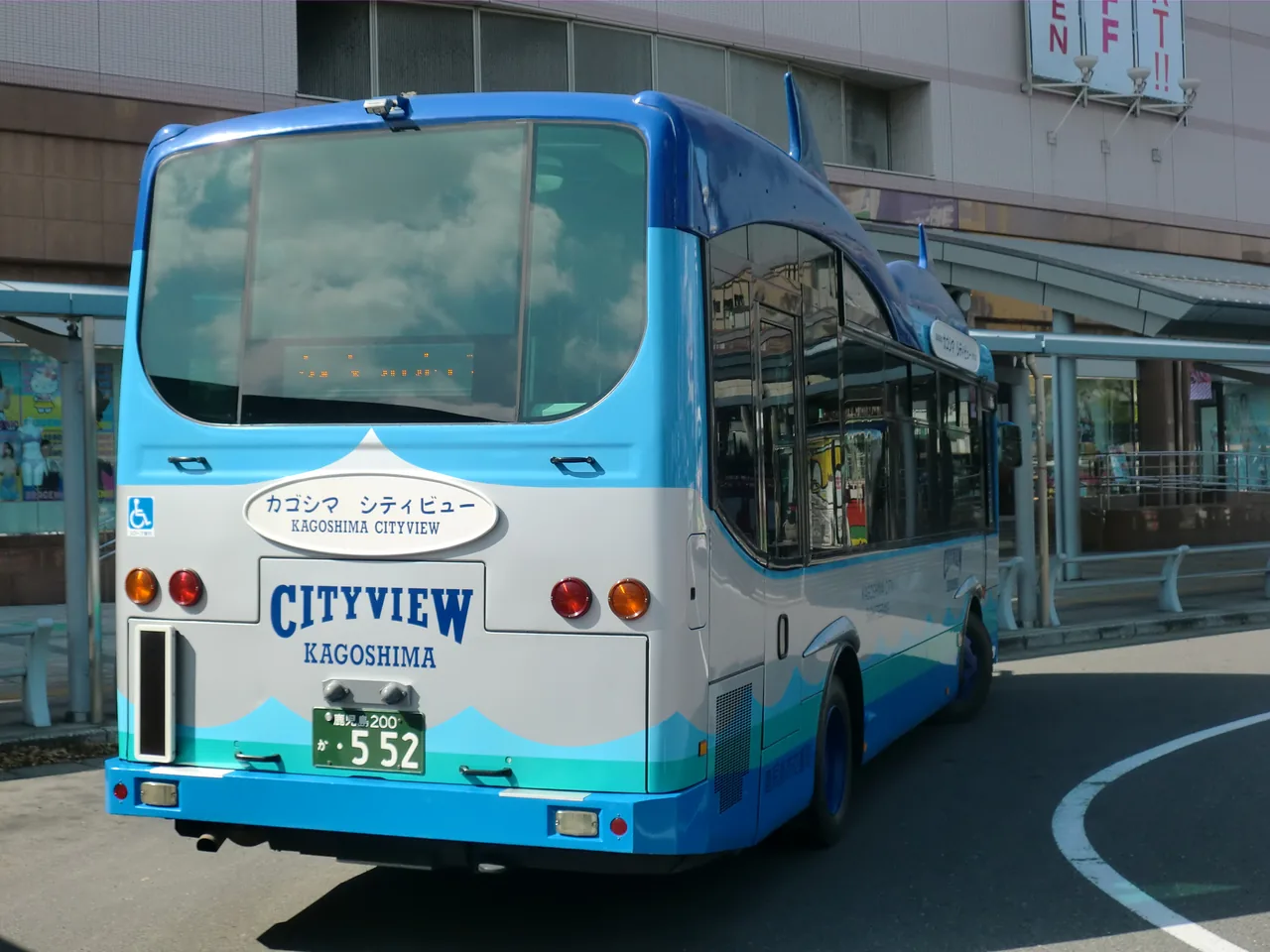 The rear of a blue and white sightseeing bus lettered CITY VIEW KAGOSHIMA