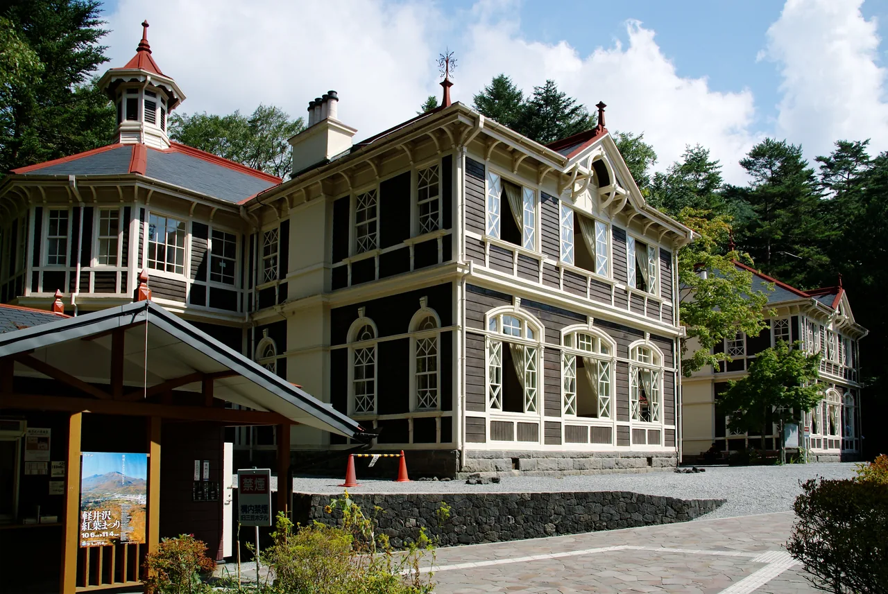 A two-storey timber building in Western style with a veranda and a tower