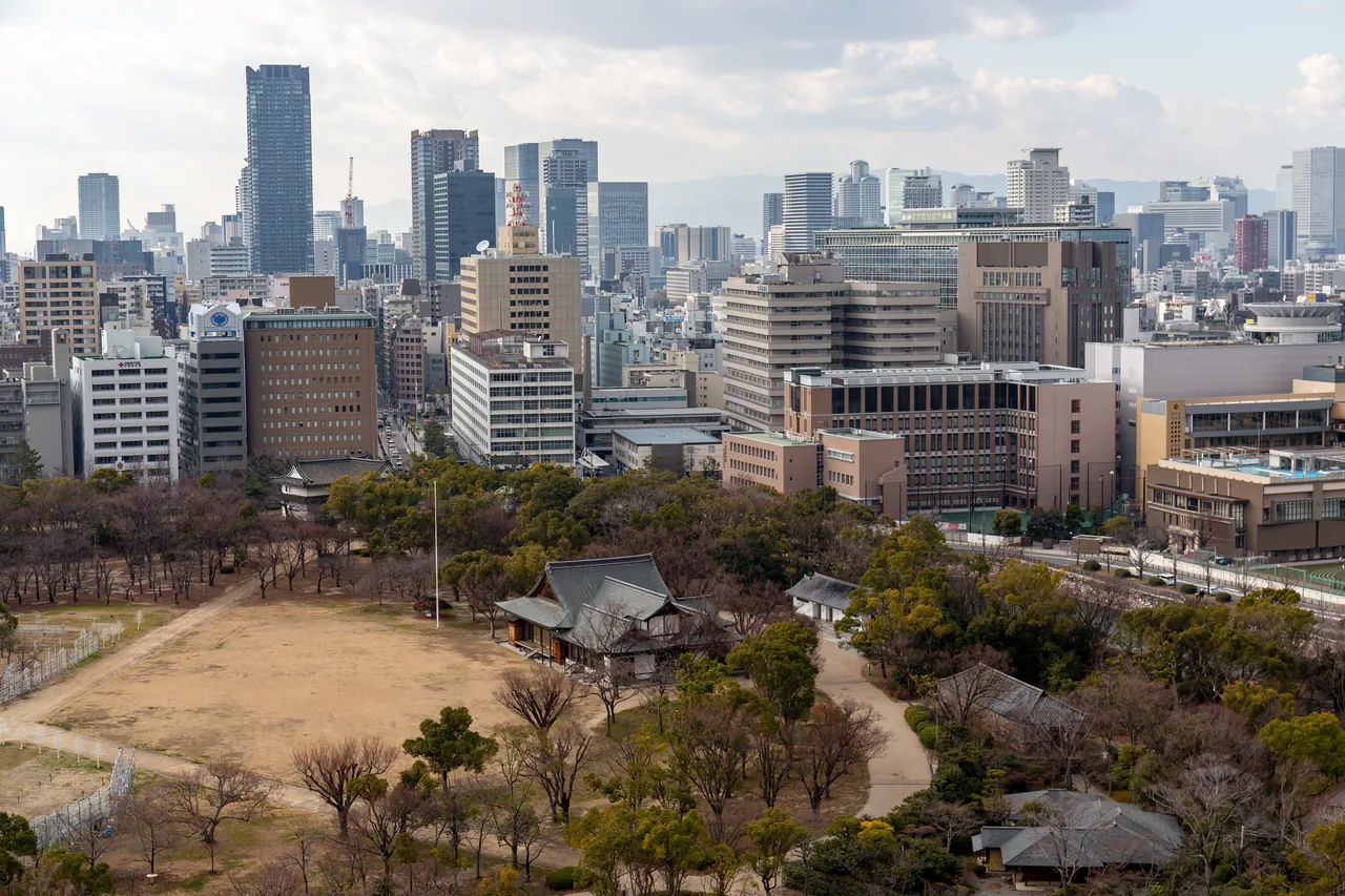 A view over central Osaka from high up, with tower blocks spreading to the horizon