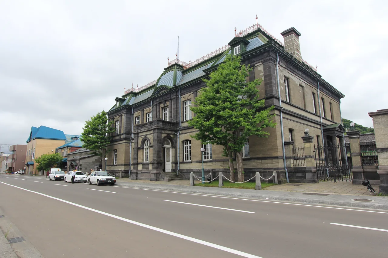 Two-storey Western-style stone building beside the road