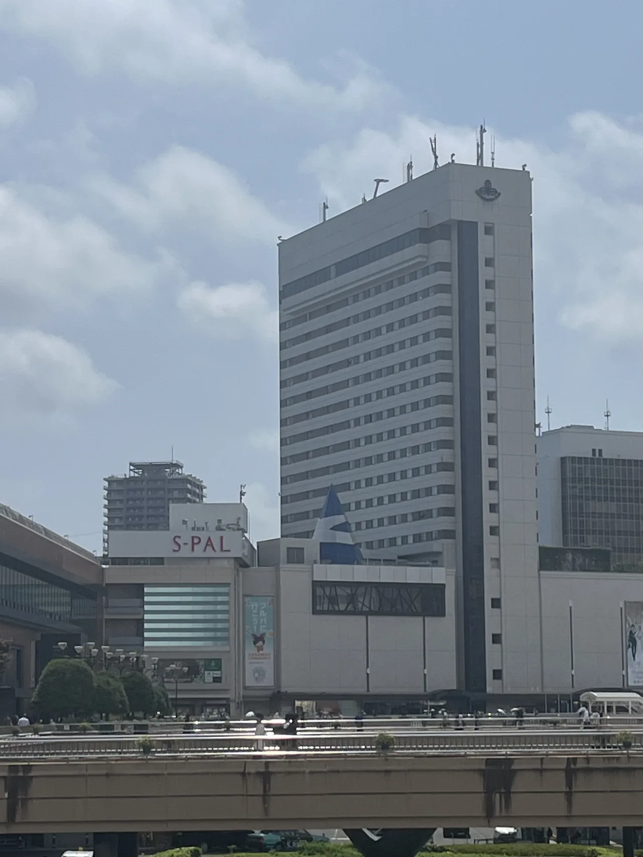 Hotel Metropolitan Sendai rising directly above the station building, with the S-PAL shopping floors and an elevated walkway in front of it
