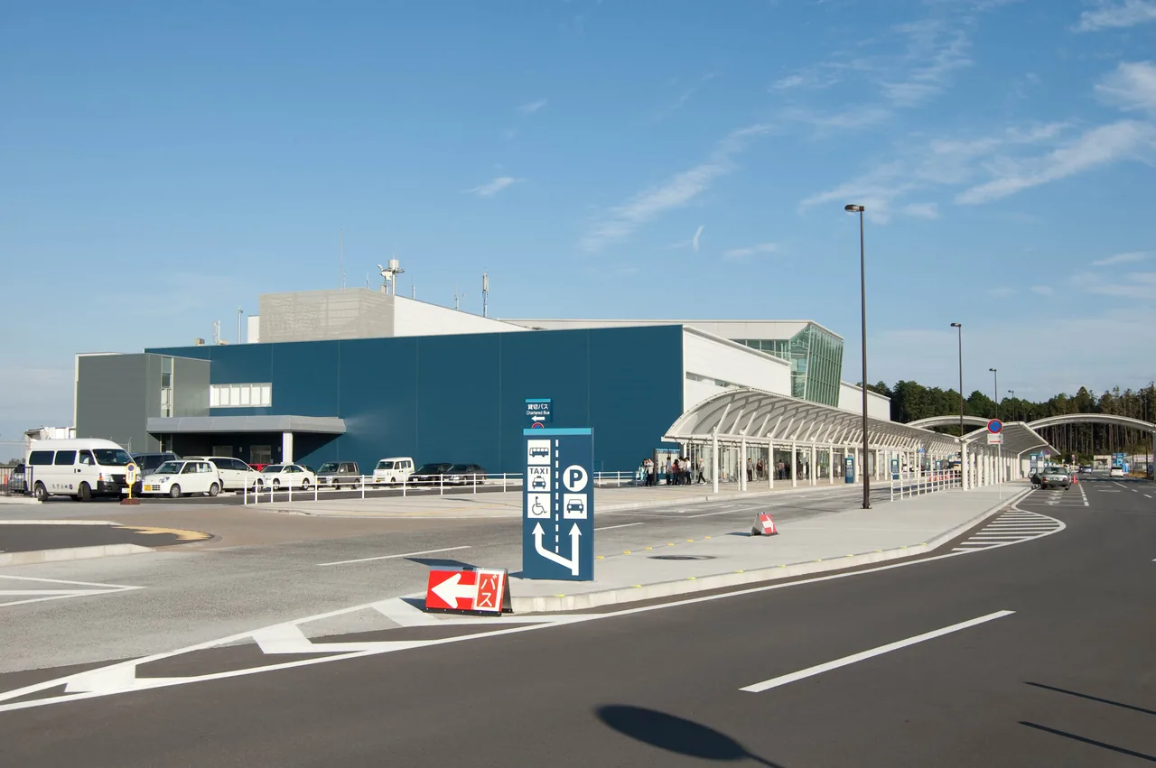 The low terminal building of Mount Fuji Shizuoka Airport with a road in front