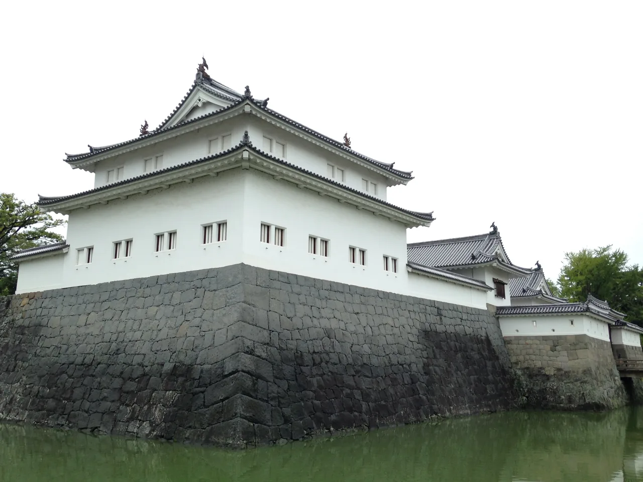 The white plastered Tatsumi turret of Sumpu Castle on its stone base