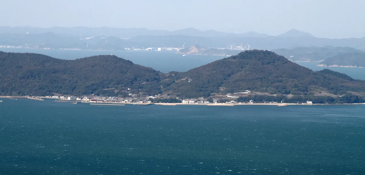 Megijima seen low across the water from Takamatsu, with hills beyond