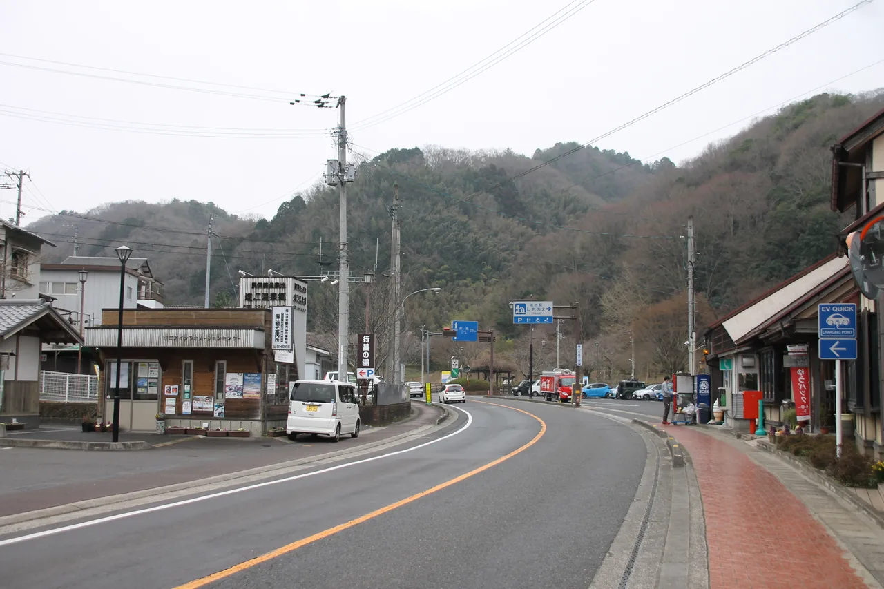 A quiet road through the Shionoe hot spring area with hills behind A quiet road through the Shionoe hot spring area with hills behind