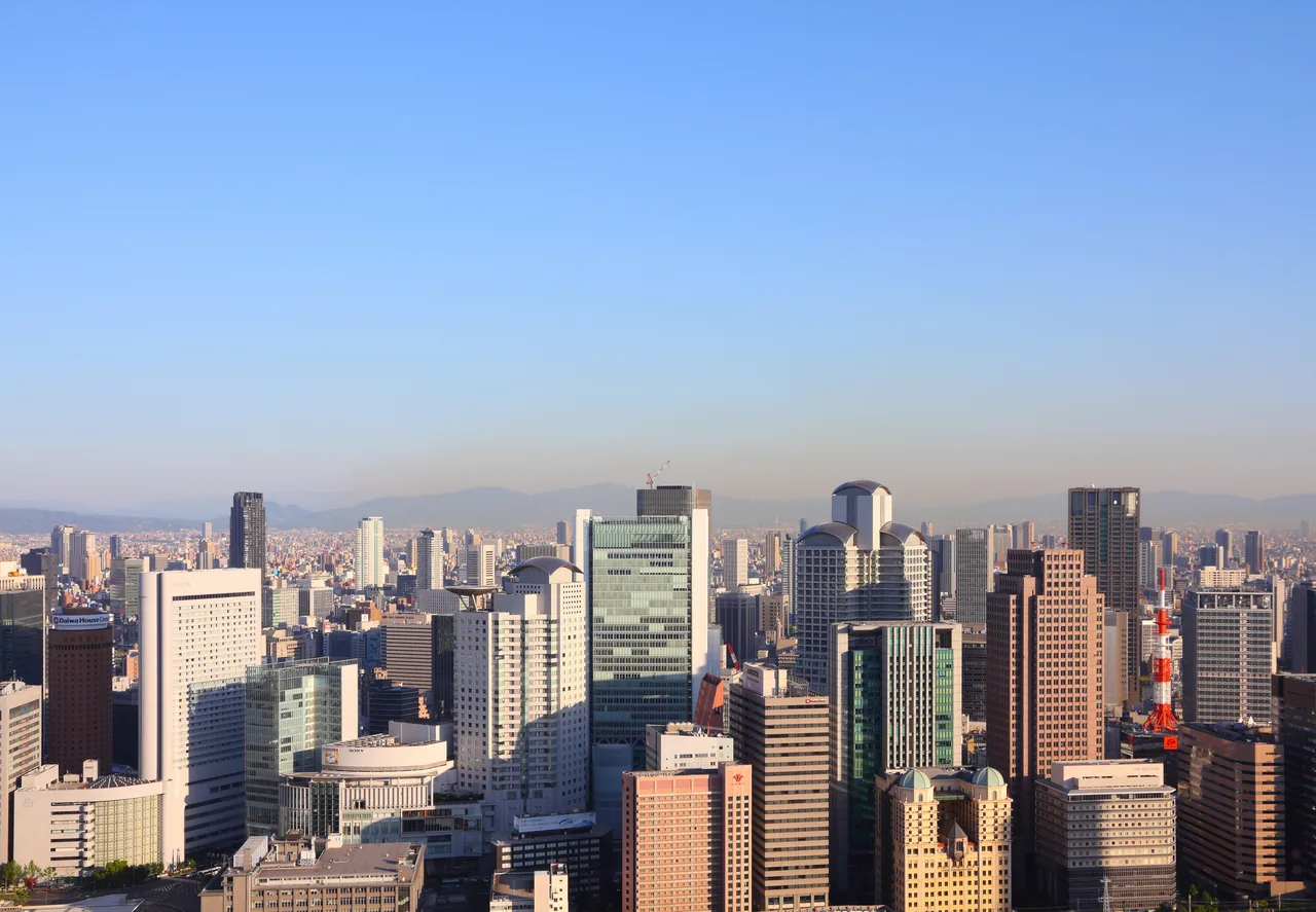 A view over central Osaka from high up, with tower blocks stretching to the horizon