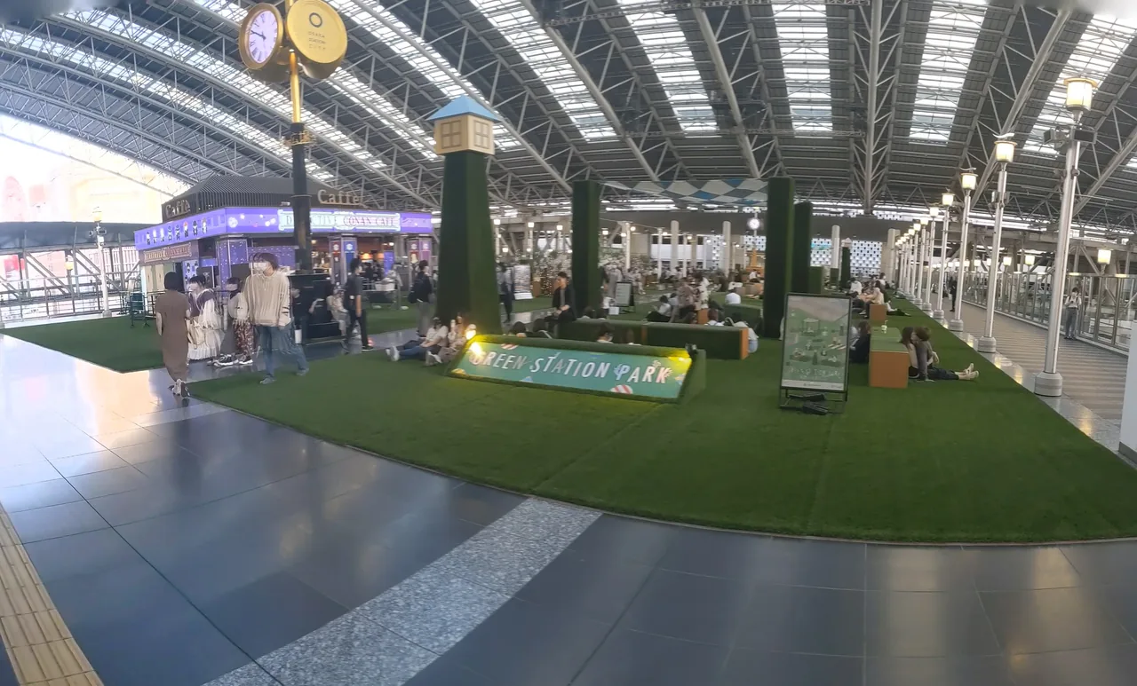 An open plaza on an upper level of Osaka Station under a large roof