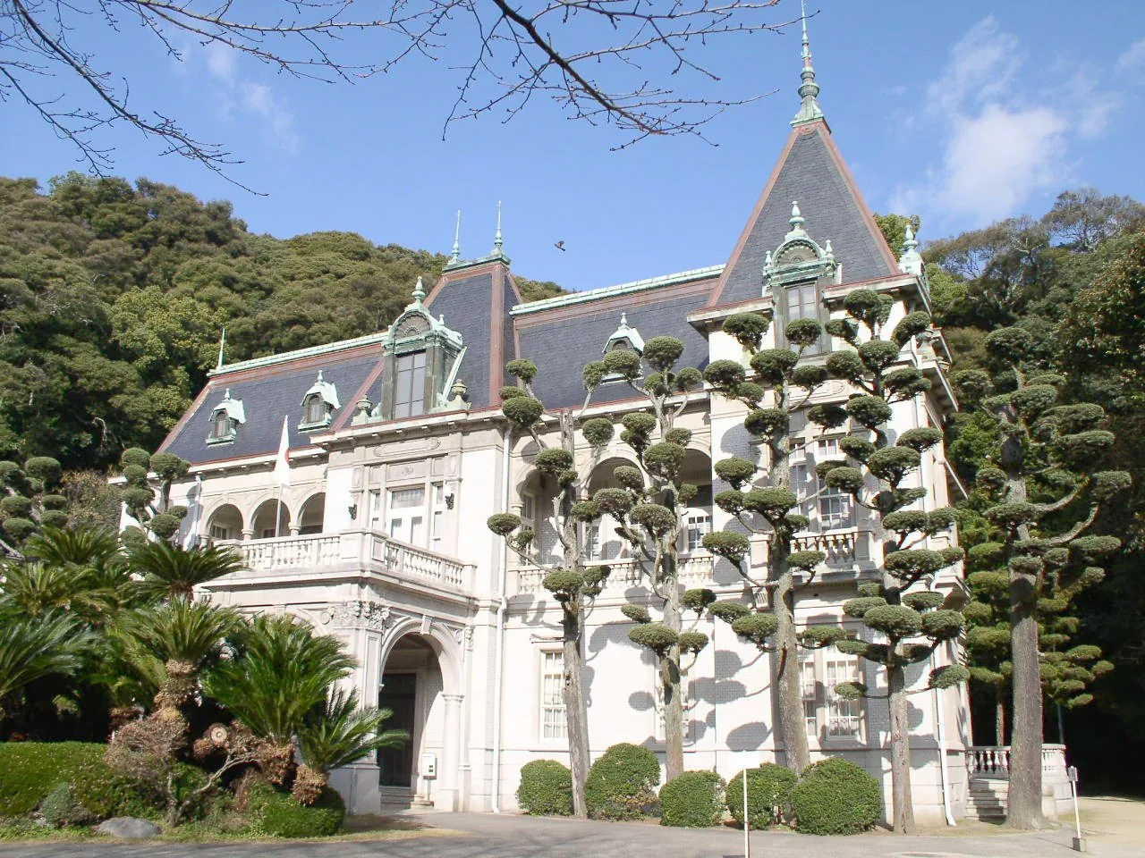 Bansuiso, a white French-style mansion against woods, partly hidden behind garden trees