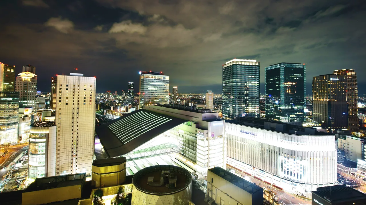 Roof of Osaka Station and the Umeda towers at night seen from above