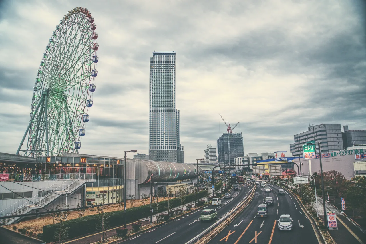 Rinku Town Ferris wheel and the Rinku Gate Tower Building beside a wide road